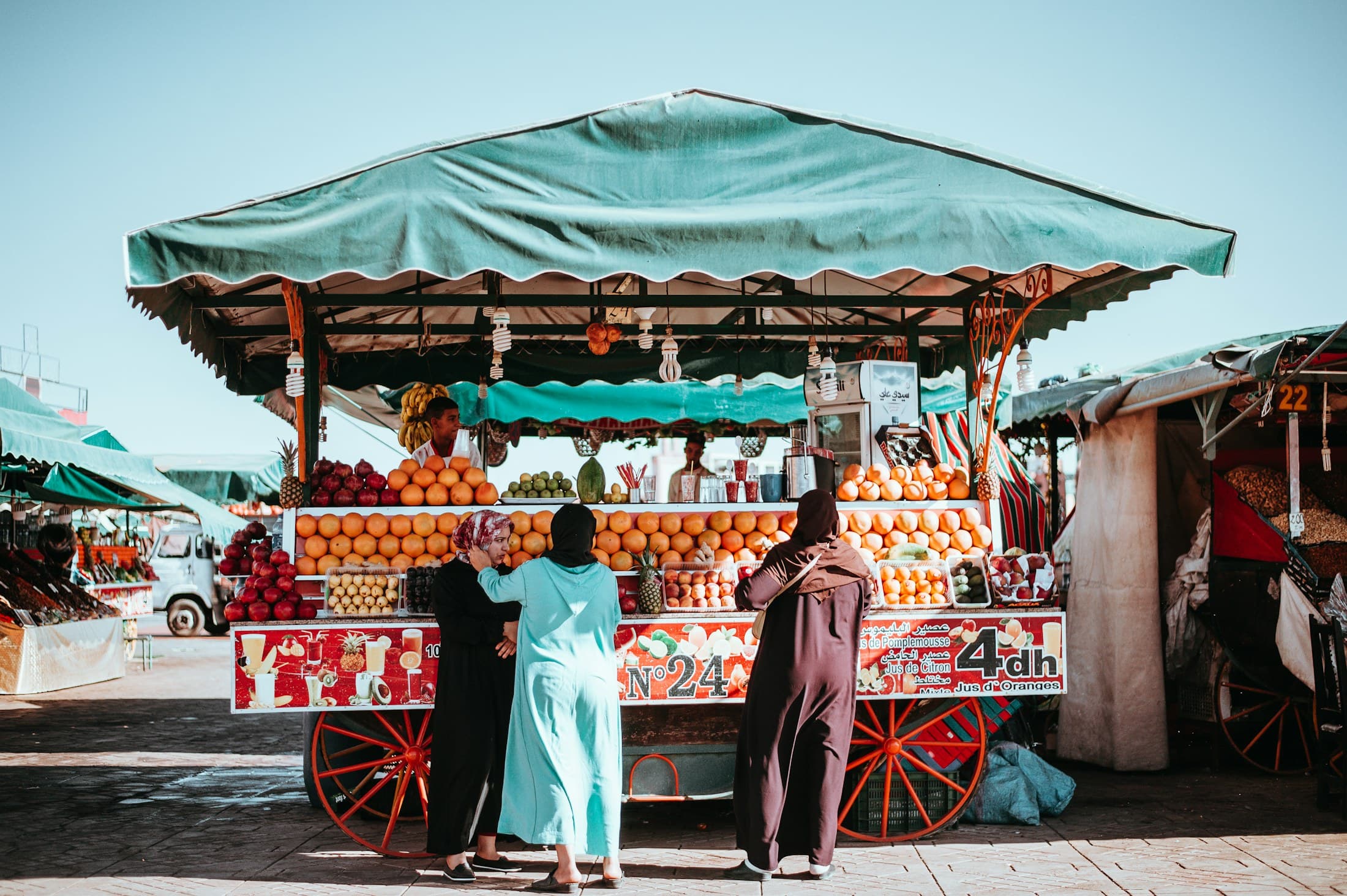 A fruit stall piled with oranges in a Marrakech market